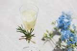 画像: <1品目:淡い思い出> メロンのクリーム&ソーダの飲むパルフェ「淡い思い出」。ローズマリーを飾ったスマートなグラスに、マイヤーレモンのジュレ、エルダーフラワーのアイス、メロン果汁を加えた微炭酸ソーダが三層に重なり、軽く混ぜて飲むと、暑い夏にぴったりな爽やかな味が広がります。