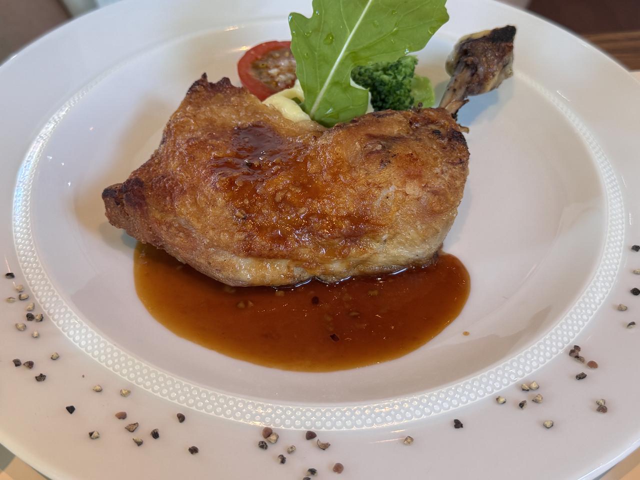 画像: 若鶏モモ肉のコンフィー ソース・オ・ポワヴル・コンカセ・アン・ユイット 香ばしい八つ割胡椒に、ブランデーと白ワイ ン、ニンニク、鶏の旨みを重ねた濃厚なソー スで仕上げました