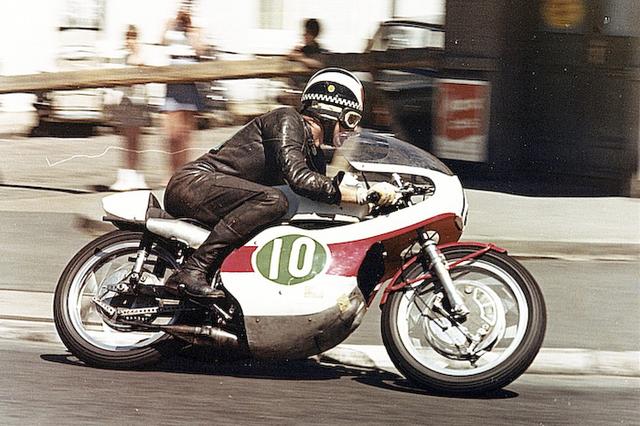 画像: 1967年のライトウェイト(250cc)TTを走るヤマハRD05Aとフィル・リード。このころGP250ccマシンは「緑地に白ヌキ文字」が規定でしたが、マン島TTではフロント側は「白地に黒文字」でした。 global.yamaha-motor.com