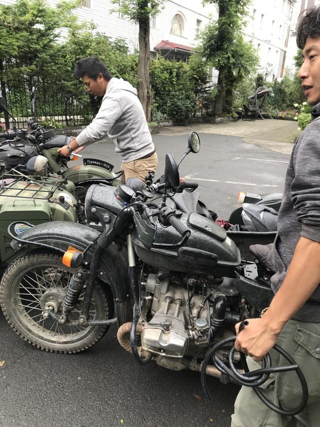 画像: ウインカーリレー交換のため、ヘッドライトをケースから外す堀内さん(左)。しかし、この後悲劇? が・・・。