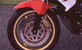 画像: ローソンのFZレーサーは、正立フロントフォークなどのフロント周りのパーツが、そっくりWGP500ccクラスを走るYZR500用ベースのものに換装されている。