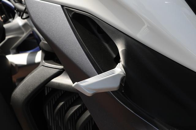 画像: 現行モデル同様のワンタッチでオープンするタイプの折りたたみ式タンデムステップを装備する。
