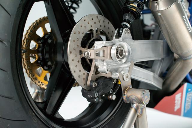 画像: リヤサスはイギリスのK-TECHで、スイングアームも同じくスイート・ファブリケーション製。車体のベースはGSX1100SD='84年型カタナで、フレームはほぼノーマルでありながらヘッドパイプ部は下の補強部を再構成などの追加工を行い、スイングアームピボットは下げられている。