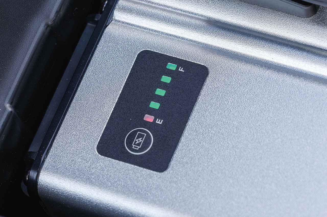 画像: 車体に積んだままでも、外して室内に持ち込んでも充電でき、バッテリー上面のインジケーターで充電量レベルが確認できる。