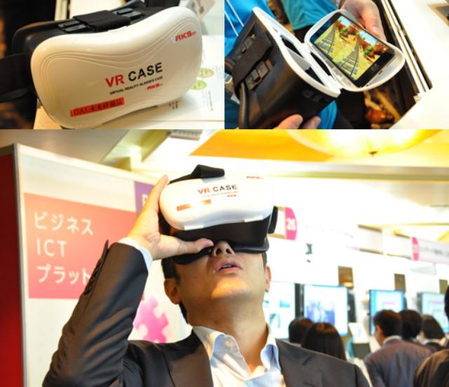 画像: 未来サービス研究所のブースでは、スマホを用いてVR(仮想現実)を体感できるアイテムを展示。はたから見ると挙動不審の動きに。