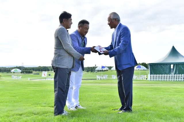 画像: 贈呈時の様子。左から株式会社JOYX前村直昭社長、小田孔明プロ、JGTO青木功会長。