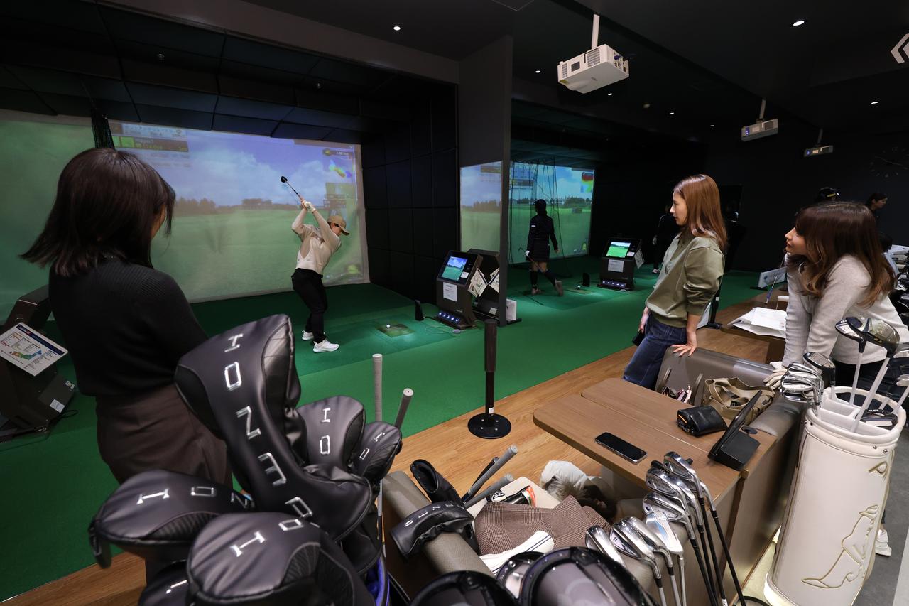 画像: すぐ近くでプロのスウィングを体感できるのは贅沢すぎるっ。隣の打席にいる別の女子プロをチラ見できちゃうのもインドアのイベントならでは