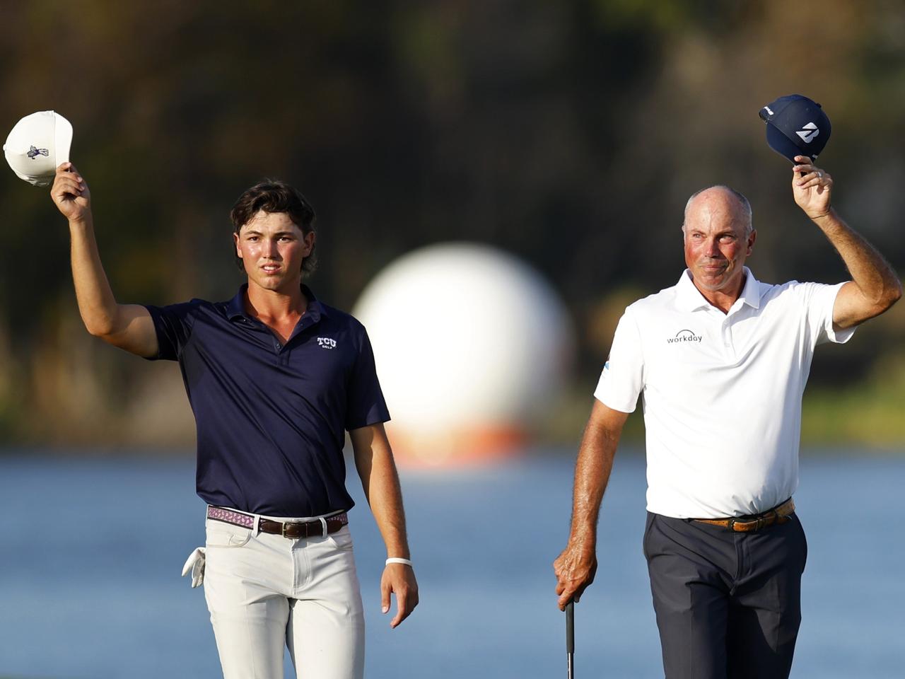 画像: キャメロン・クーチャー（左）とマット・クーチャー（右）。最終18番ホールのグリーンに上がる前にギャラリーに挨拶（PHOTO/Getty Images）