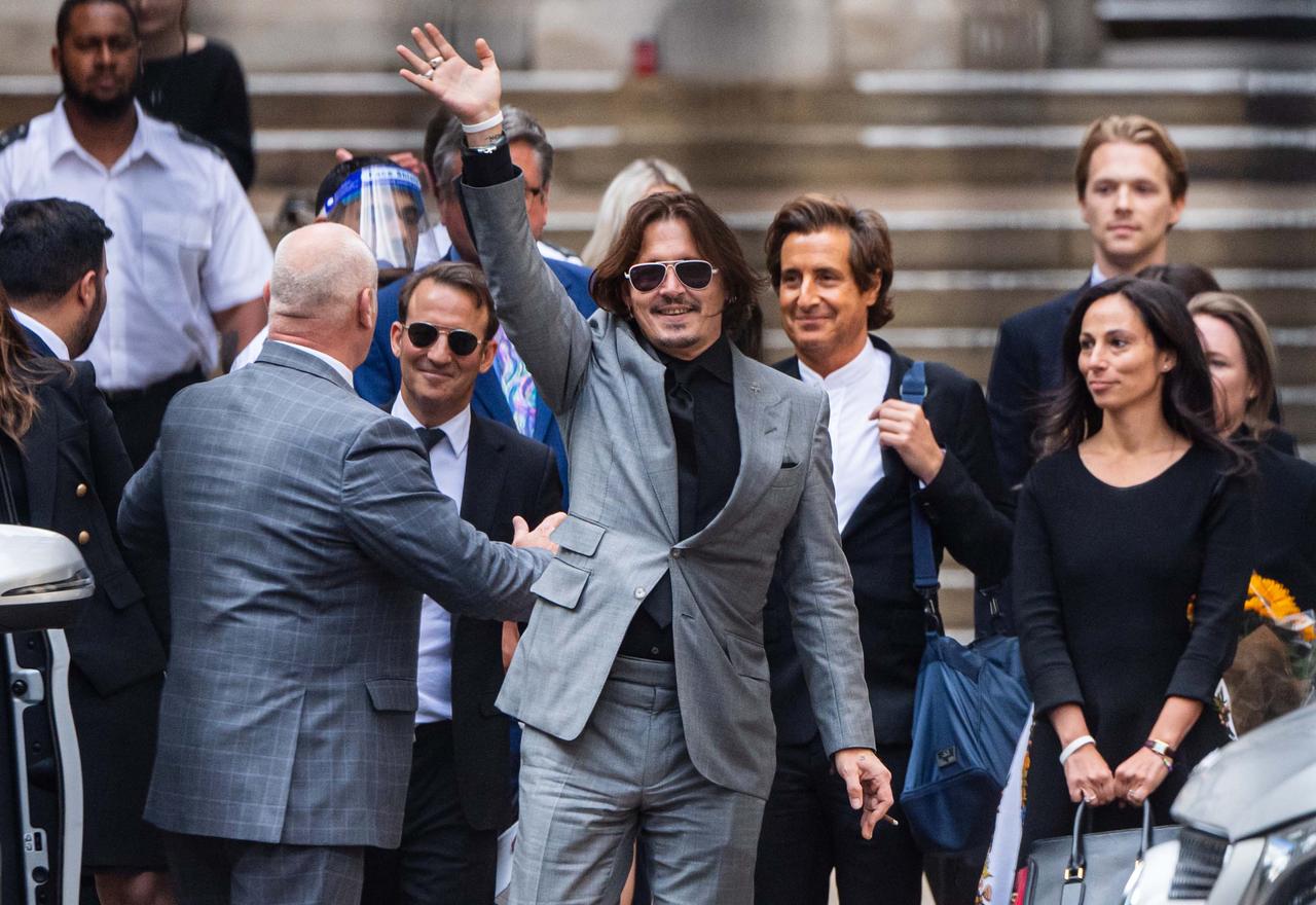 画像: 2020年、英サン紙を訴えたジョニーがロンドンの王立裁判所に出廷し、観衆に手を振って応えるところ Photo by Samir Hussein/WireImage