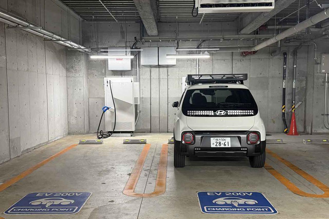 画像: フロントグリルDC／ACともに充電口が装備されているインスタクロスは、充電スタンドが写真のように設置されていると前側から駐車枠に駐めることになる。充電後は、バックでここから出ることになる。