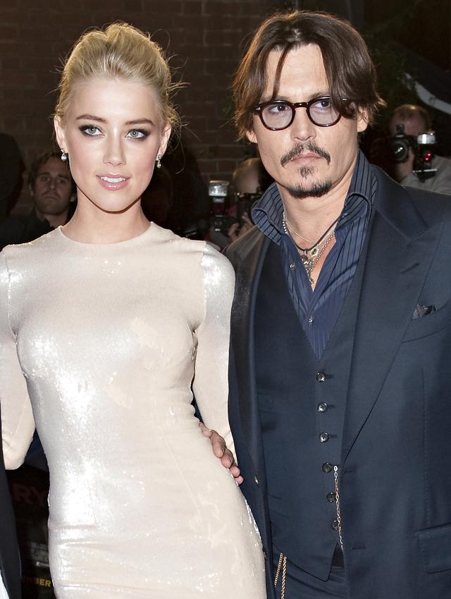 画像: アンバー・ハードとジョニー・デップ。交際のきっかけとなった2011年の共演作『ラム・ダイアリー』のロンドンプレミアにて。