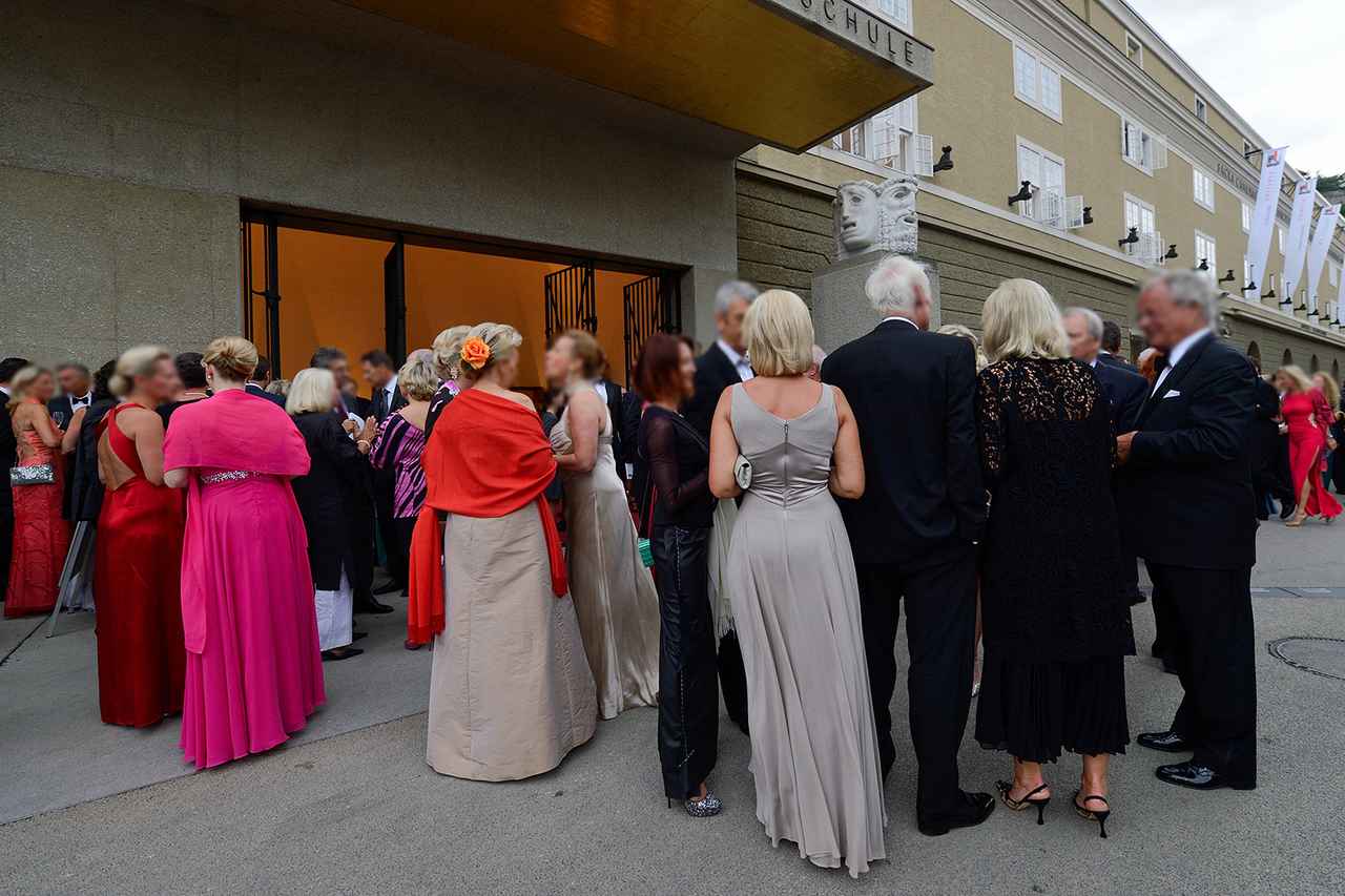 画像: 観光客が見ている祝祭劇場前風景