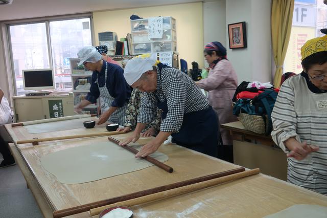 画像: 真剣な表情で蕎麦生地を伸ばすエコーさん