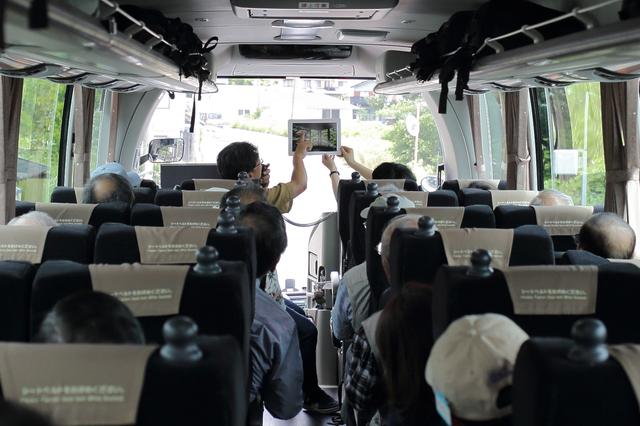 画像: バスの車内。最前列の席にて旧竹林院での撮影アドバイスをする竹下講師
