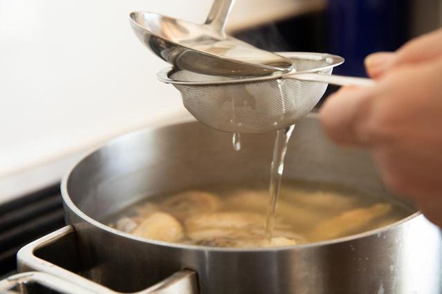 画像: 鶏肉がやわらかく煮えたら、にんじんの煮汁を漉しながら加える