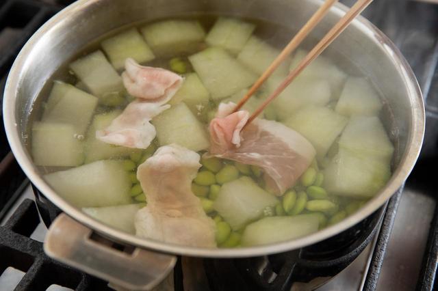 画像: 豚肉を入れ、あくを取りながら煮て、豚肉の色が変わったら火を止める。スープを器に盛り、生姜オイルをかける。