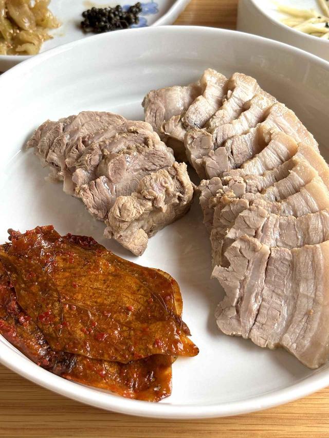 画像: 豆の葉で包んでいただく茹で豚