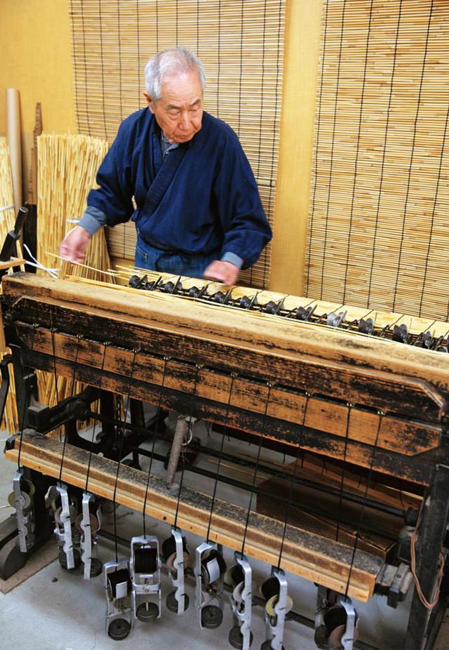 画像: 50年ほど使いつづけている機械で編む田中さん。軽やかにみえるが、ペダルはずっしりと重い。一般的なすだれ1枚を、1時間半ほどで編む