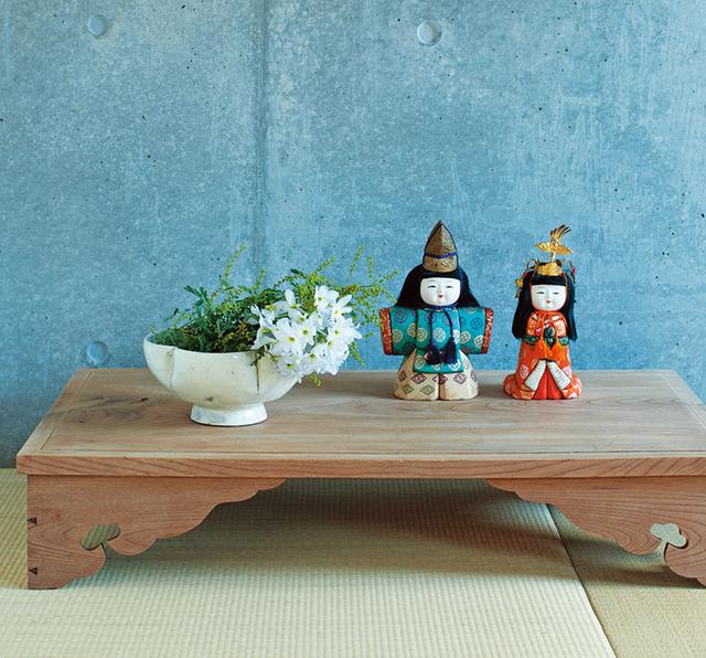 画像: 日本の古道具の台におひな様をのせ、ミモザとリューココリーネを活けて祝いのしつらいに。コンクリートの壁と畳の質感が、あえて新鮮な演出