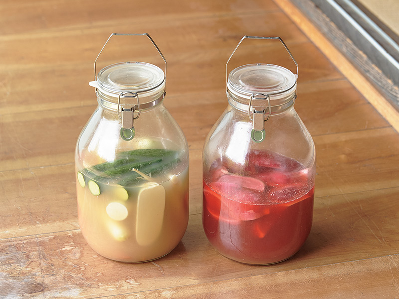 画像: 乳酸発酵させてつくる漬物。赤は赤かぶ、大根、白はにんじん、大根、きゅうり。野菜の重さに対して3〜5%の塩をまぶし、毎日手で混ぜる。水が上がったら塩をまぶした野菜を漬ければいい
