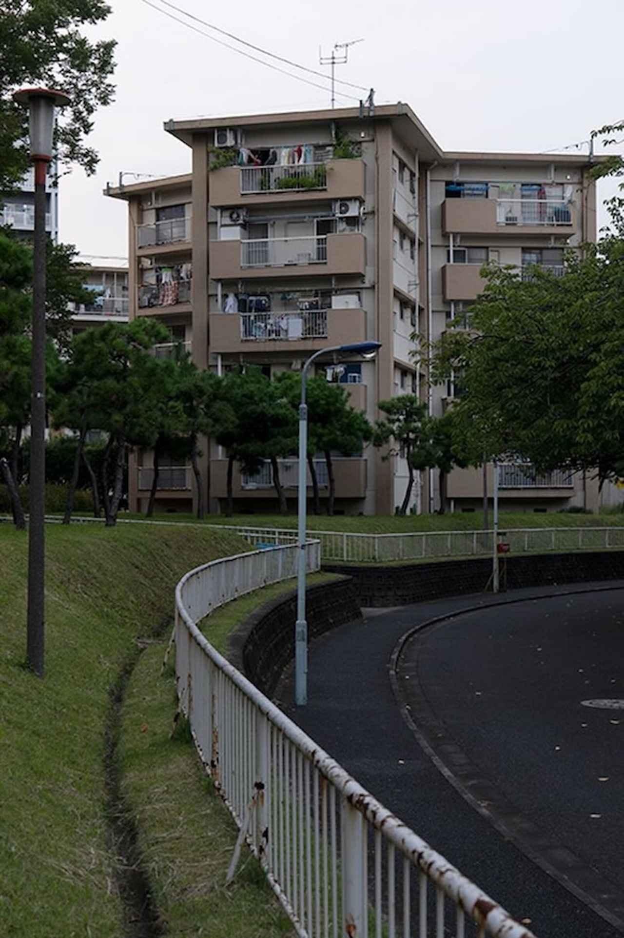 画像: 赤羽駅側の道路から見た「スターハウス住棟」。右側の街灯は「陣笠タイプ」と呼ばれる昭和の団地定番のデザイン。いまではすっかり見かけなくなりました
