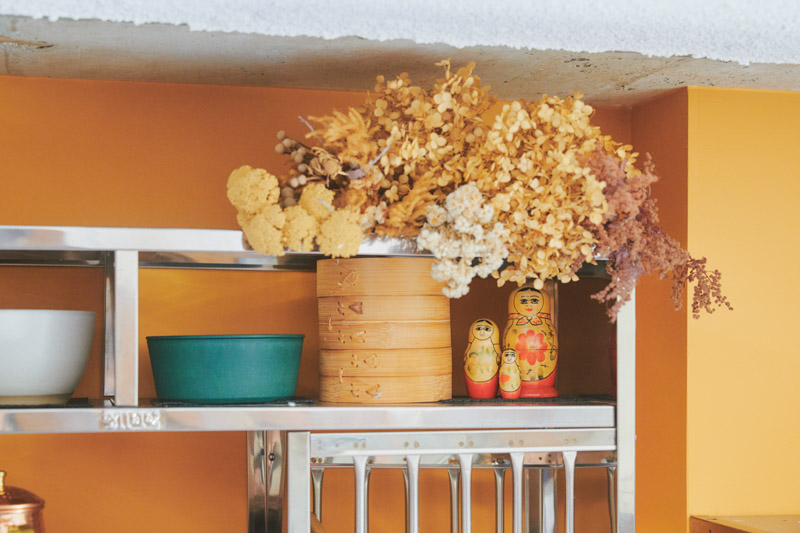 画像: キッチンの一角。ドライフラワーや人形で目を楽しませる工夫も