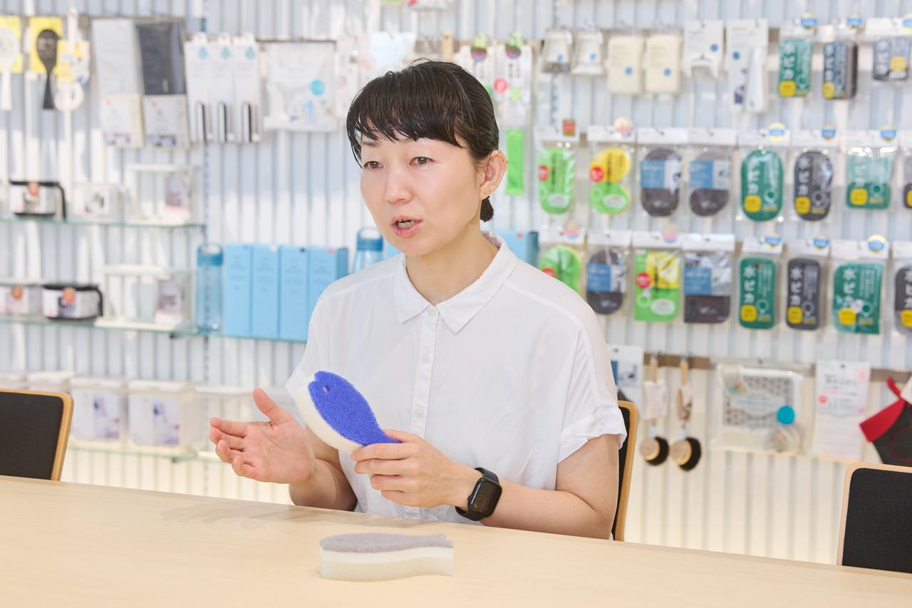 画像: "スポンジ博士"と呼ばれている長野さん。スポンジのほかにもキッチンツールや掃除アイテムなど、担当分野は多岐にわたる