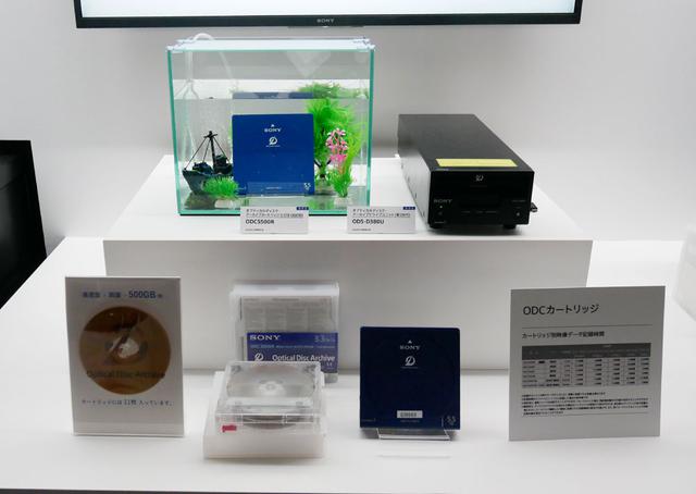 画像: ▲CEATECでも展示されていたアーカイブシステムの最新モデル。ディスクの読み出し速度はおよそ1.7倍に高速化されているそう。ディスク容量は1カートリッジあたり500GBになった(片面3層、両面で6層のディスクが11枚収納されている)