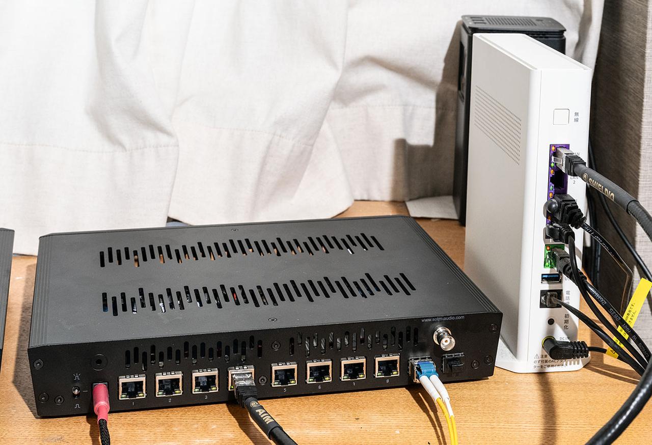 画像: 執筆室に設置したsNH-10G。モデムの出力をルーター機能付きのハブに入れ、そこからsNH-10Gに金属線のRJ45ケーブルで入力、長さ10mの光LANケーブルでオーディオルームに引き込んだ