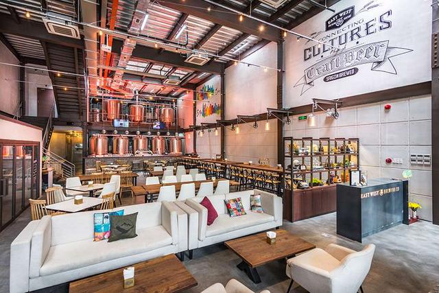 画像: 奥にビール樽が見える1階の店内。週末のみ開放される2階席はオープンエアで、気分爽快(© East West Brewing Co.)