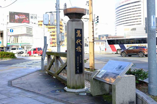 画像: 萬代橋よりもずっと手前(駅方面)にかつての萬代橋の親柱が立っていました。昔の萬代橋は今よりも長く川幅も広かったため、かつては親柱が立っているところから橋が始まっていたそうです。