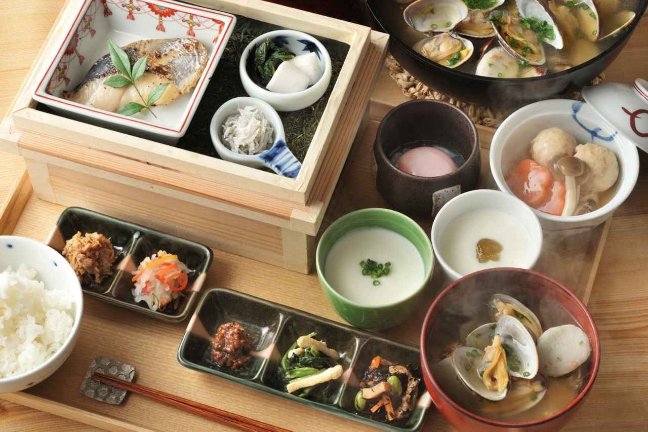 Image 2: Tea picking exercises to regulate the body and breath, followed by a breakfast of tea boxes filled with a refreshing aroma