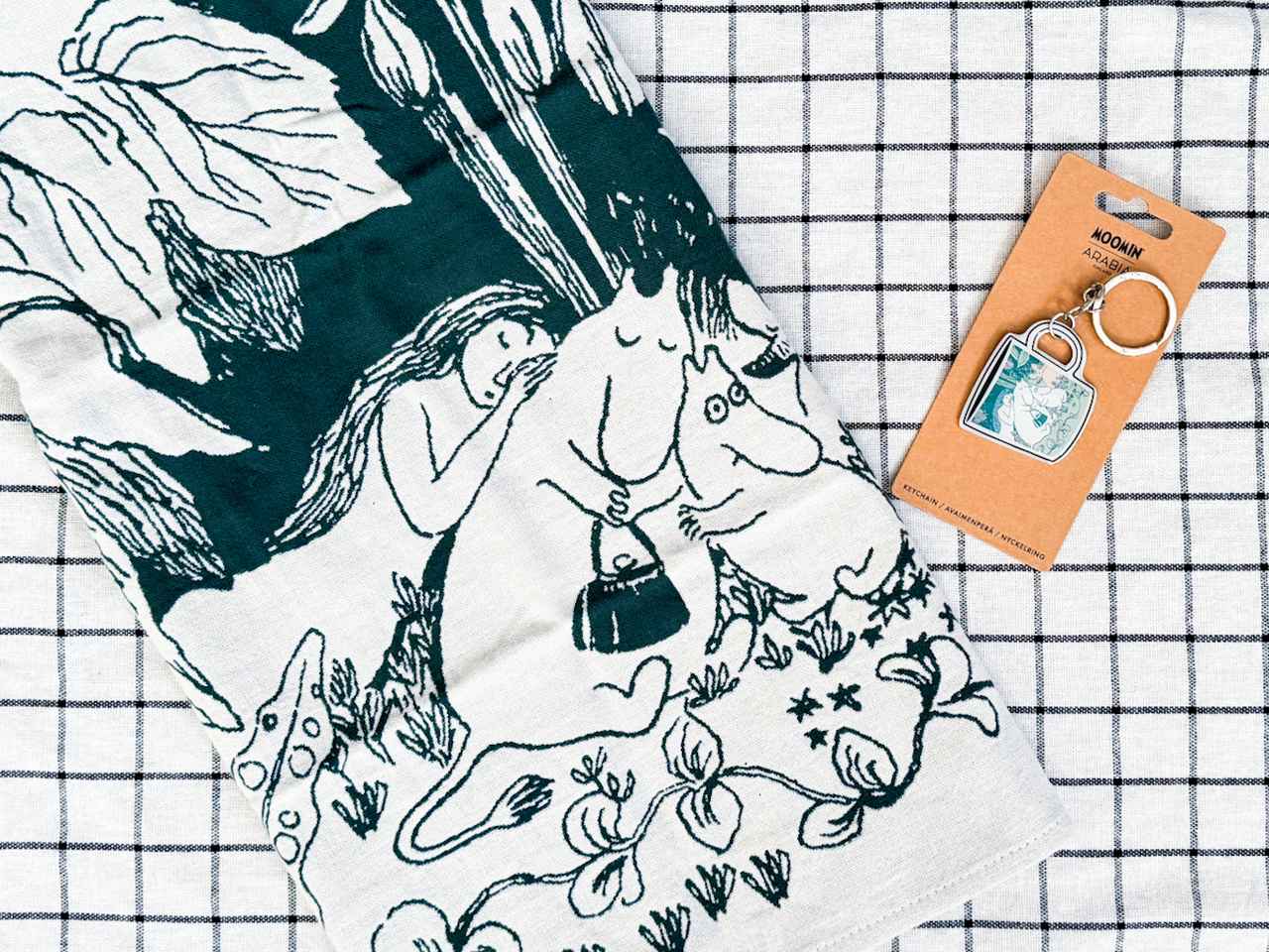 画像: © Moomin Characters ™ 左：ムーミンの日限定キッチンナプキン16.90ユーロ（日本円で約3,040円）、右：ムーミンの日限定キーホルダー4.90ユーロ（日本円で約880円）／アラビアで購入