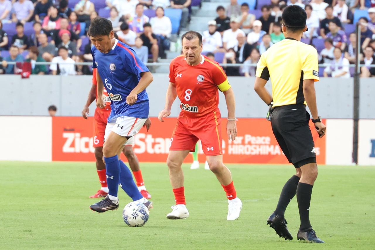 画像 : 7番目の画像 - 【写真】試合前には日本代表の森保一監督からメッセージ動画が流され、アイドルグループ・STU48によるオープニングアクトも。往年の名選手が広島の地で競演した。試合後はモネールと中澤佑二の「お尻ぶつけダンス」も！（写真◎石倉利英） - サッカーマガジンWEB