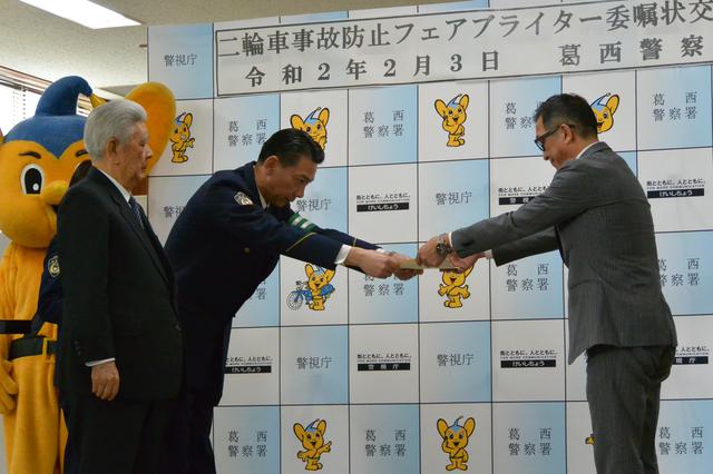 画像: 二輪車販売店らに二輪車事故防止フェアブライター委嘱状を手渡す半田署長(左から2人目)