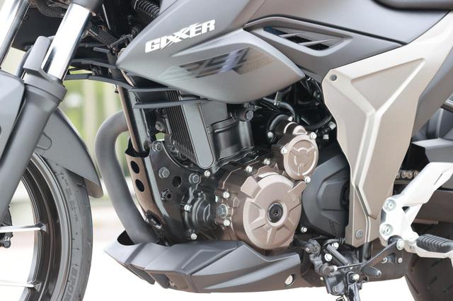画像: ジクサー250のエンジン。電動冷却ファンを装備したオイルクーラーが見て取れる。
