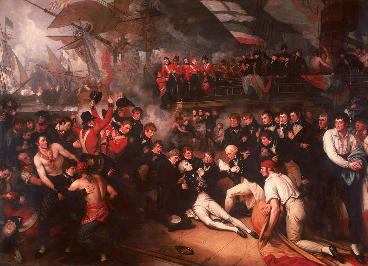 画像: 1805年に行われたイギリス軍とフランス軍による戦い「トラファルガーの海戦」終了後、息を引き取るネルソン提督を描いた絵画。制服を着用しているのは士官以上の階級がある船員